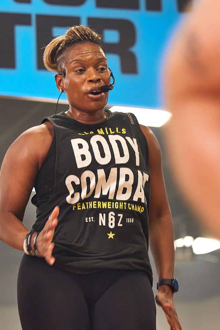 class instructor leading a group of eos gym members in workout