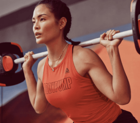 close up shot of athletic person performing a barbell squat
