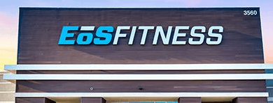 Exterior view of an EoS Fitness gym with prominent branding on the building