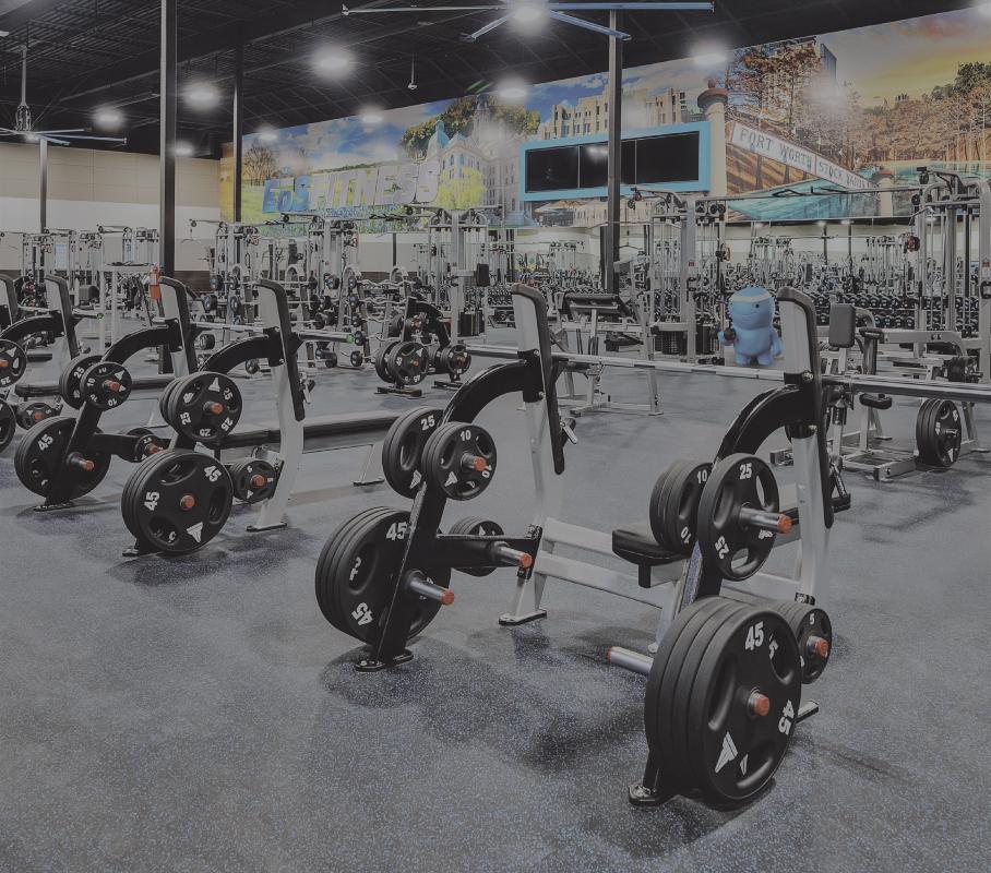 wide show of workout benches and other barbell strength equipment in an eos branded gym