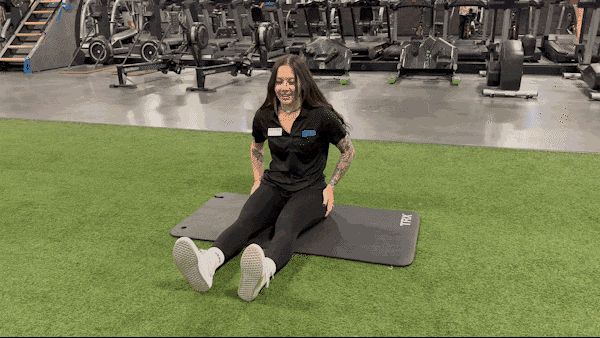eos yoga instructor doing seated forward pose