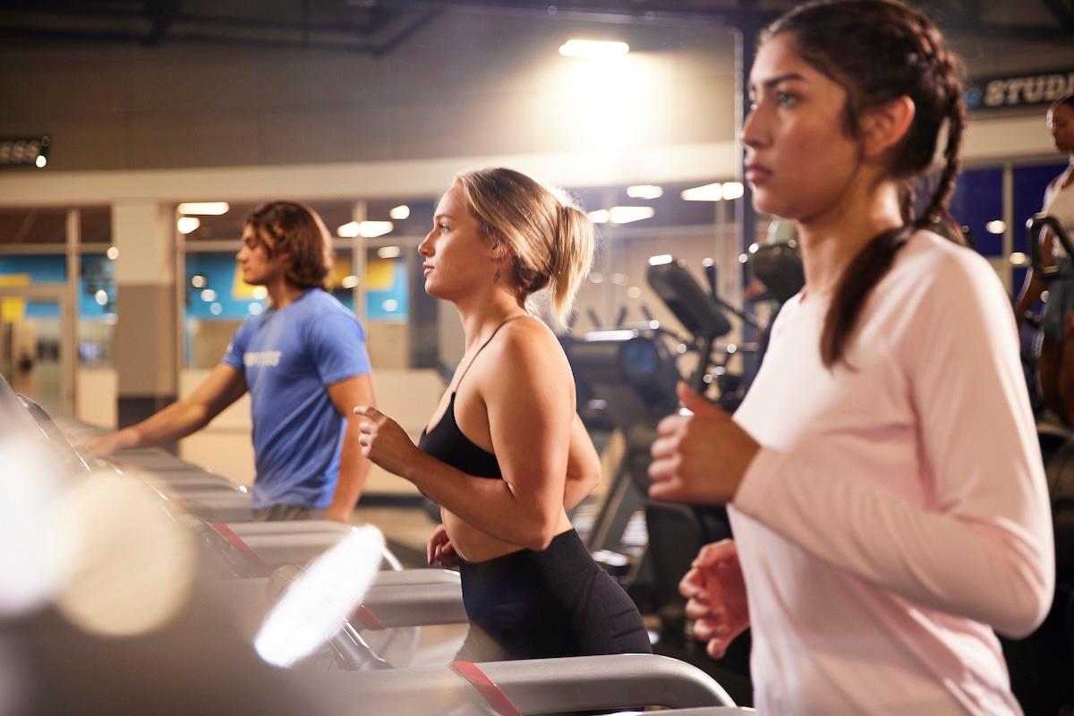 group of eos gym members walking on treadmills together