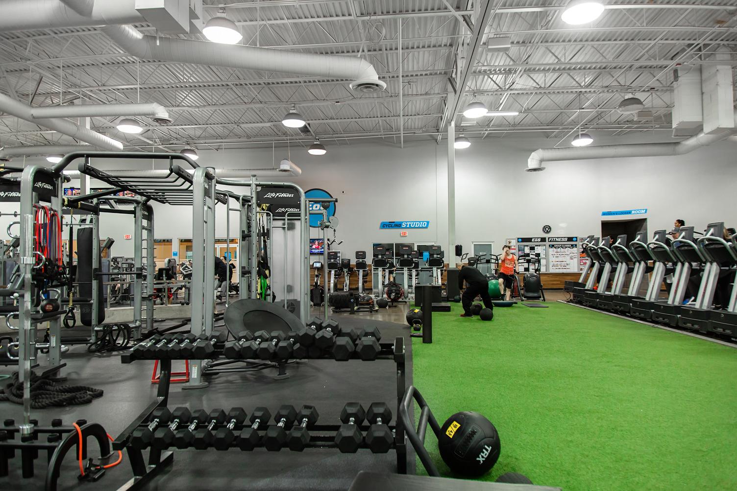 open turf area with free weights and machines 