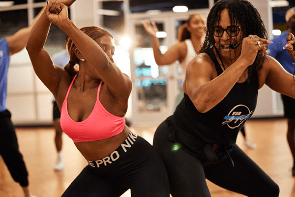 two eos gym members having fun at dance class