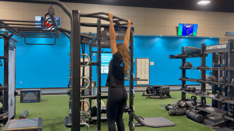 eos fitness member performing a dead hang