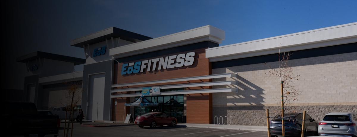 outside shot of a modern eos gym with brick walls and bright blue branding sign
