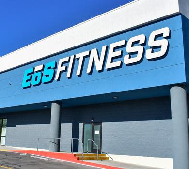 outside shot of a modern eos gym with brick walls and bright blue branding