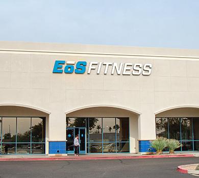 outside shot of a modern eos gym with brick walls and bright blue branding