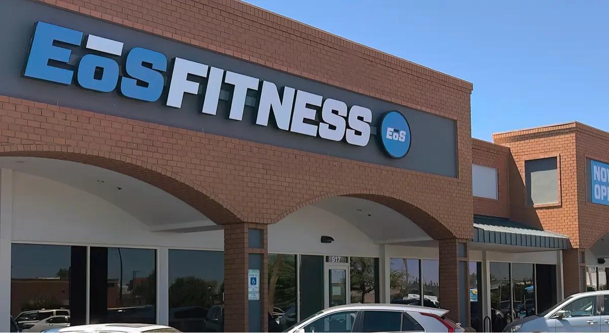 outside shot of a modern eos gym with brick walls and bright blue branding