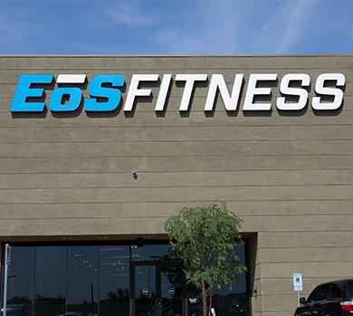 outside shot of a modern eos gym with brick walls and bright blue branding