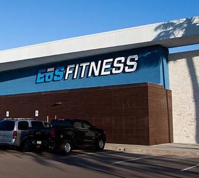 outside shot of a modern eos gym with brick walls and bright blue branding