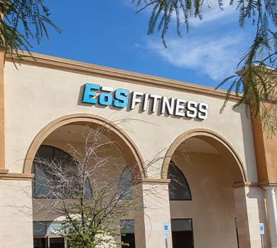 outside shot of a modern eos gym with brick walls and bright blue branding