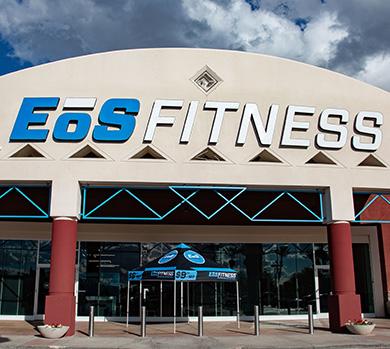 outside shot of a modern eos gym with brick walls and bright blue branding