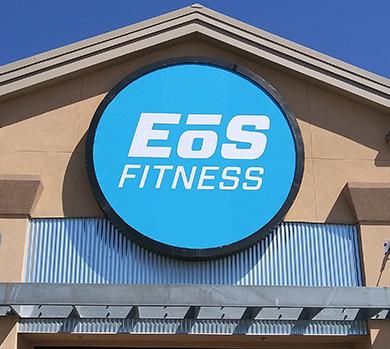 outside shot of a modern eos gym with brick walls and bright blue branding