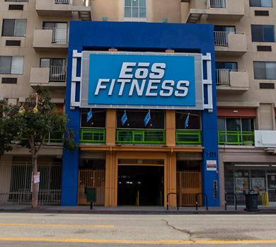 outside shot of a modern eos gym with brick walls and bright blue branding