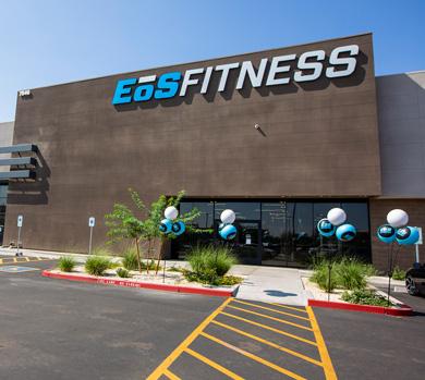 outside shot of a modern eos gym with brick walls and bright blue branding