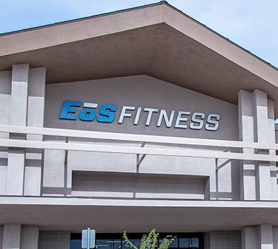 outside shot of a modern eos gym with brick walls and bright blue branding