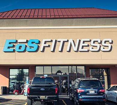 outside shot of a modern eos gym with brick walls and bright blue branding