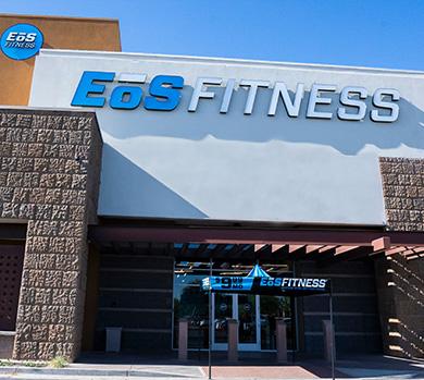 outside shot of a modern eos gym with brick walls and bright blue branding