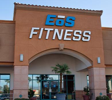 outside shot of a modern eos gym with brick walls and bright blue branding