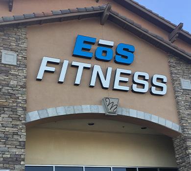 outside shot of a modern eos gym with brick walls and bright blue branding