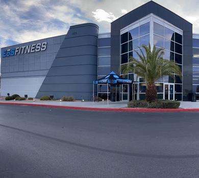 outside shot of a modern eos gym with brick walls and bright blue branding