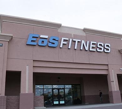 outside shot of a modern eos gym with brick walls and bright blue branding