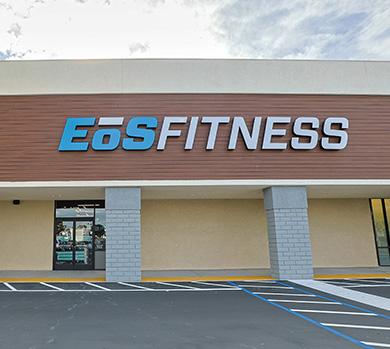 outside shot of a modern eos gym with brick walls and bright blue branding