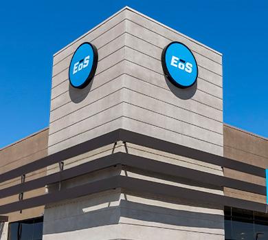 outside shot of a modern eos gym with brick walls and bright blue branding
