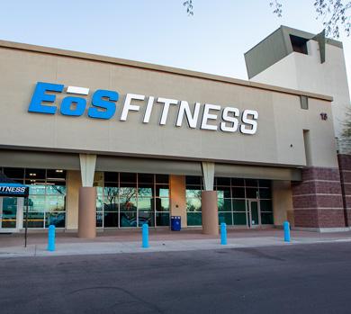 outside shot of a modern eos gym with brick walls and bright blue branding