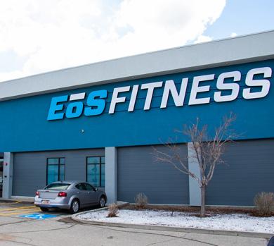 outside shot of a modern eos gym with brick walls and bright blue branding