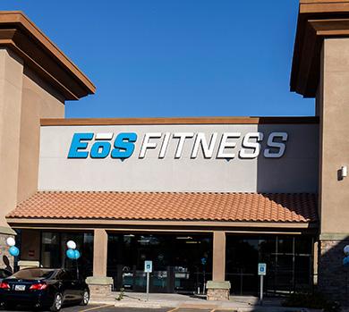 outside shot of a modern eos gym with brick walls and bright blue branding