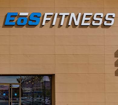 outside shot of a modern eos gym with brick walls and bright blue branding