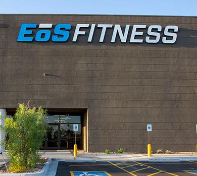 outside shot of a modern eos gym with brick walls and bright blue branding