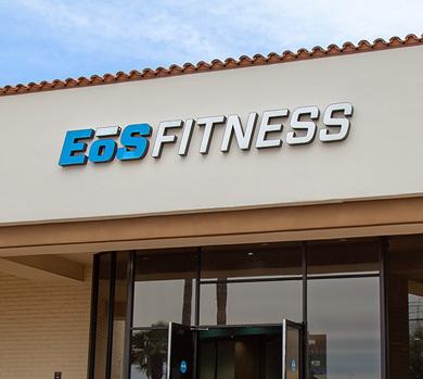 outside shot of a modern eos gym with brick walls and bright blue branding