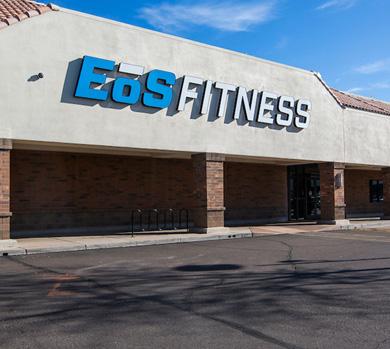outside shot of a modern eos gym with brick walls and bright blue branding