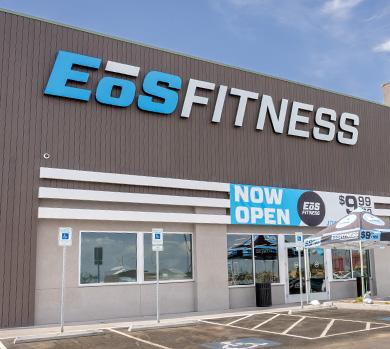 outside shot of a modern eos gym with brick walls and bright blue branding