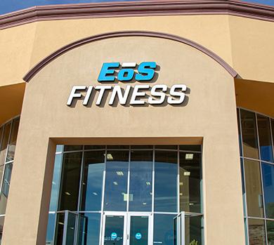 outside shot of a modern eos gym with brick walls and bright blue branding
