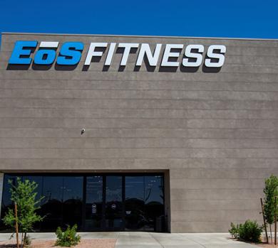 outside shot of a modern eos gym with brick walls and bright blue branding