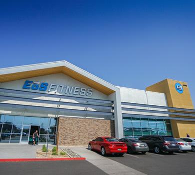 outside shot of a modern eos gym with brick walls and bright blue branding