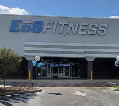 outside shot of a modern eos gym with brick walls and bright blue branding
