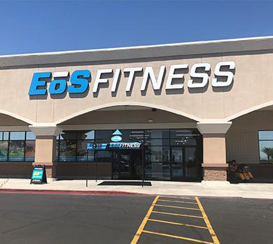 outside shot of a modern eos gym with brick walls and bright blue branding