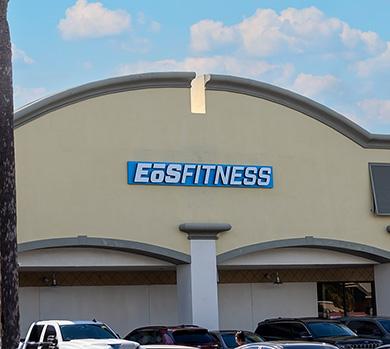 outside shot of a modern eos gym with brick walls and bright blue branding