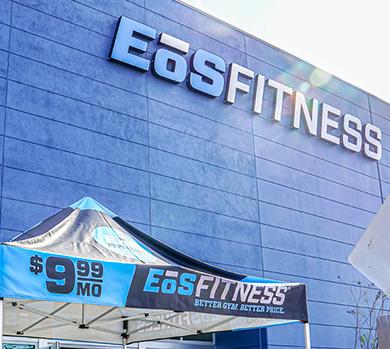 outside shot of a modern eos gym with brick walls and bright blue branding