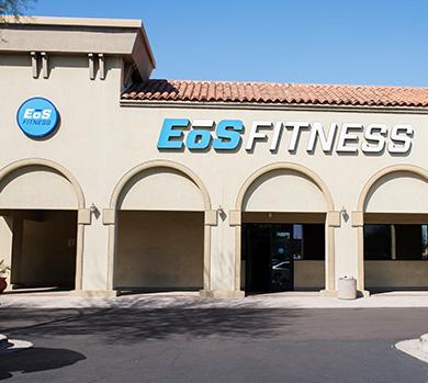 outside shot of a modern eos gym with brick walls and bright blue branding