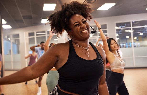 smiling eos gym member in a well lit dance studio