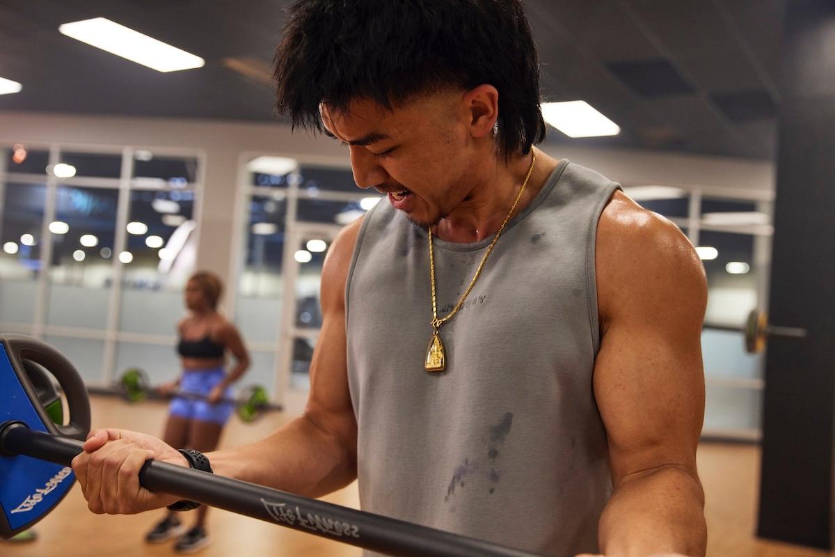 group of energetic eos gym members working out together is modern studio