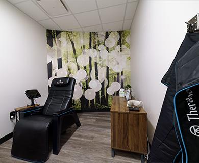 a massage chair in a white room with floral decorations