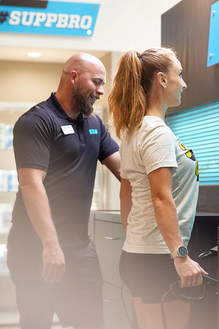 eos staff  helping gym member scan using the evolt