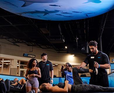 a group of eos gym members getting stretched on tables by staff
